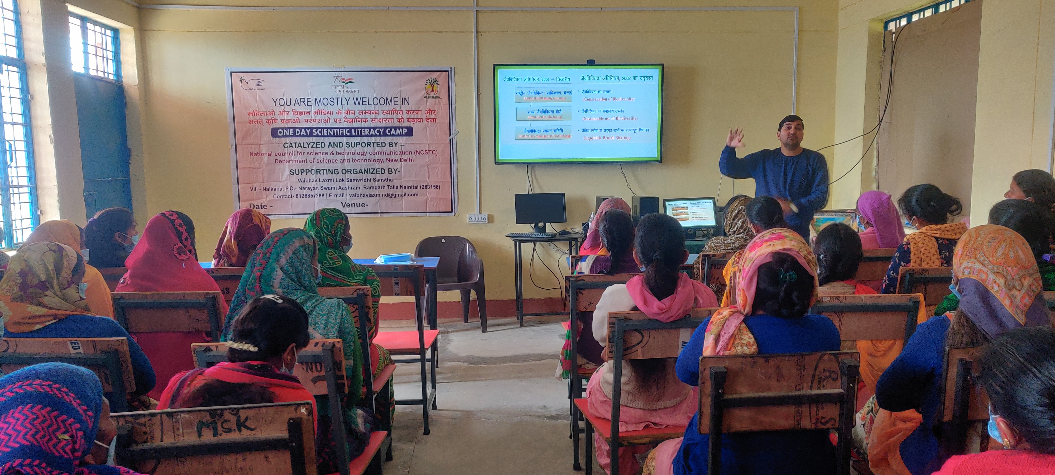 A speaker addresses women attending a classroom learning session.